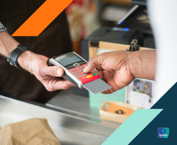 Photo of a person paying with a credit card at a retail store