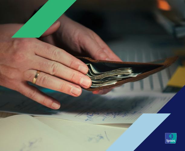person putting money in wallet while doing paperwork