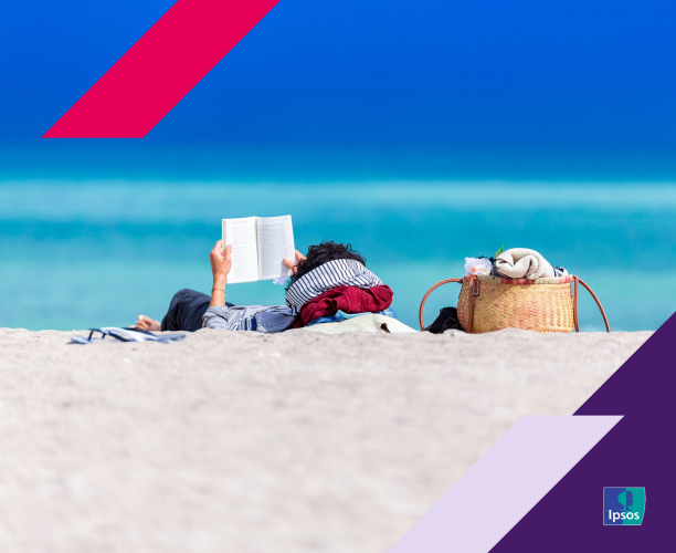 person sitting on beach reading a book