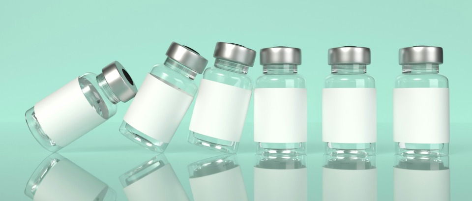 vaccine bottles falling like dominos