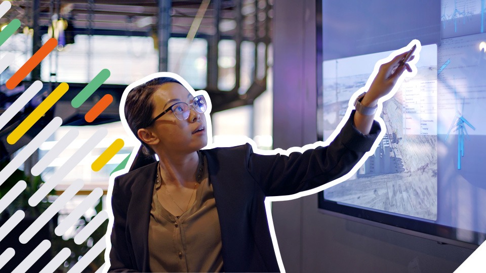 woman in office looking at engineering designs for wind turbines