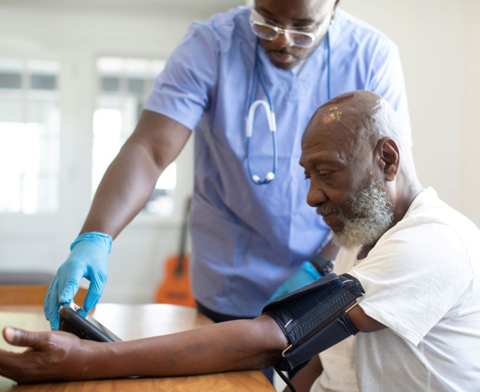Patient having blood pressure taken by doctor