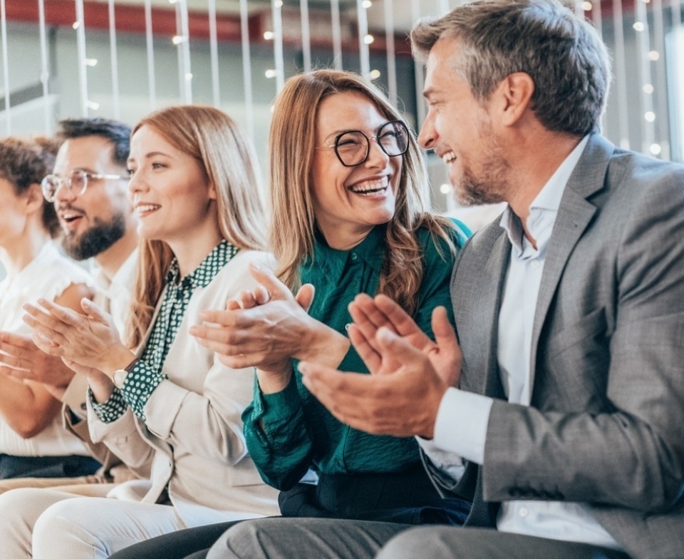 A few people laugh and clap hands