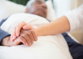 Patient and nurse holding hands